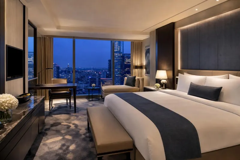 Modern hotel suite with a city view — hotel booking system module